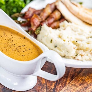 Bacon gravy in a white gravy boat.