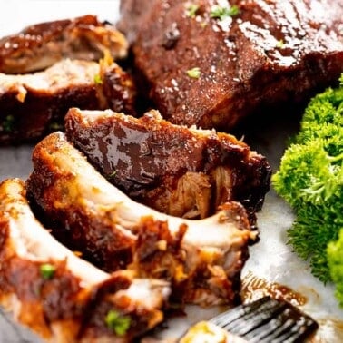 Close up of pulled ribs off the rack of slow Cooker Ribs on a marble slab.