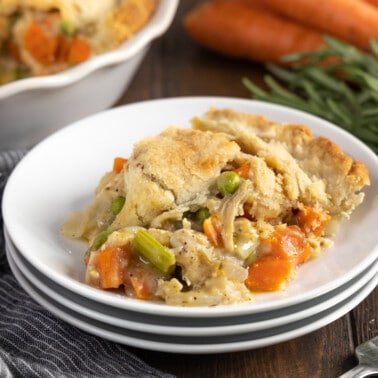 A serving of turkey pot pie on a stack of plates.