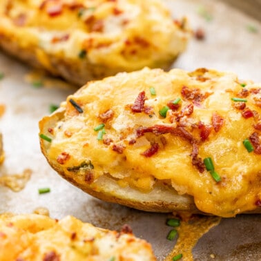 Close up view of twice baked potatoes on a baking sheet.